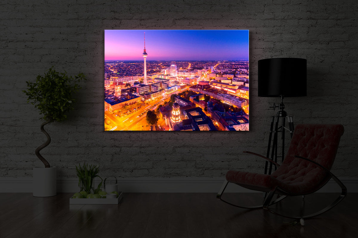 leuchtbild mit dem Motiv Berlin City in einem dunklen Raum. Das Bild leuchtet rot im abgedunkelten Zimmer